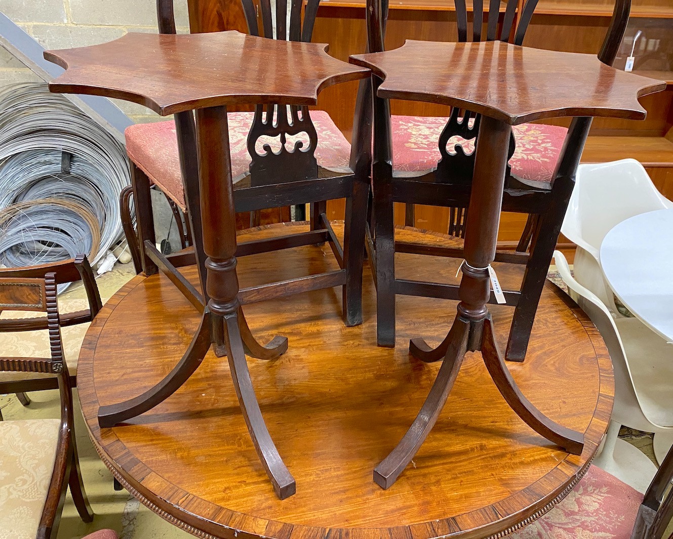 A pair of Regency style mahogany tripod wine tables with shaped circular tops, width 50cm, height 72cm